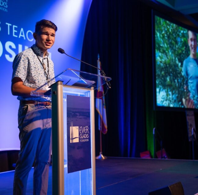 Keynote speaker Isaac Nelson at the Everglades Teacher Symposium podium