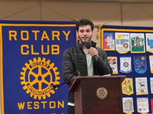 Student speaking at a Rotary Club of Weston meeting podium