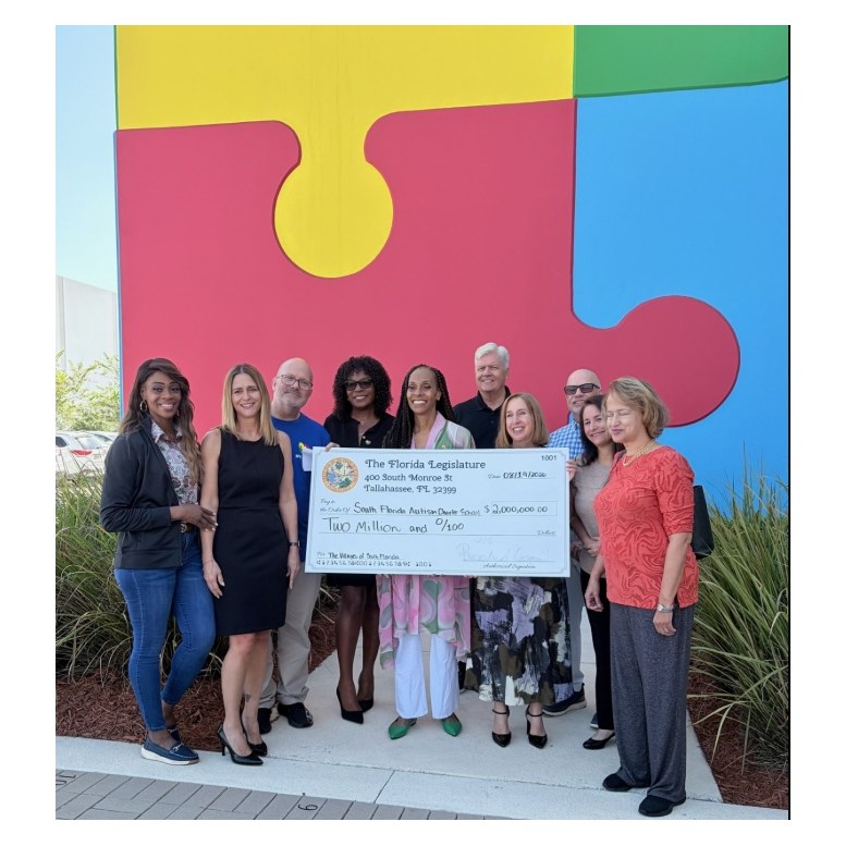 Representative Robin Bartleman and supporters holding a $2 million ceremonial check
