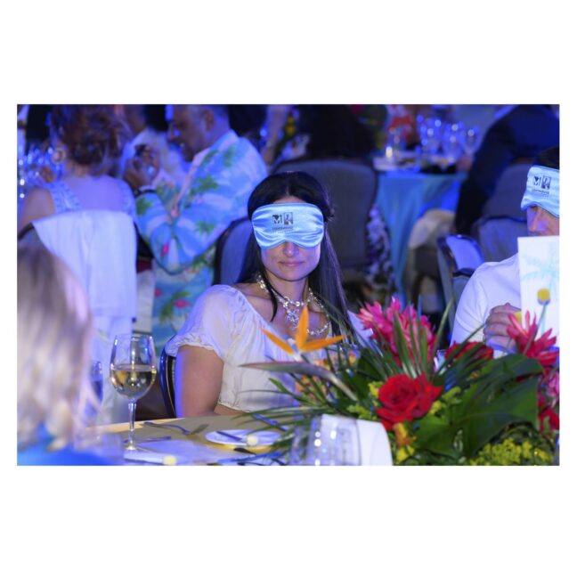 Guest wearing a blindfold at a Dining in the Dark dinner table