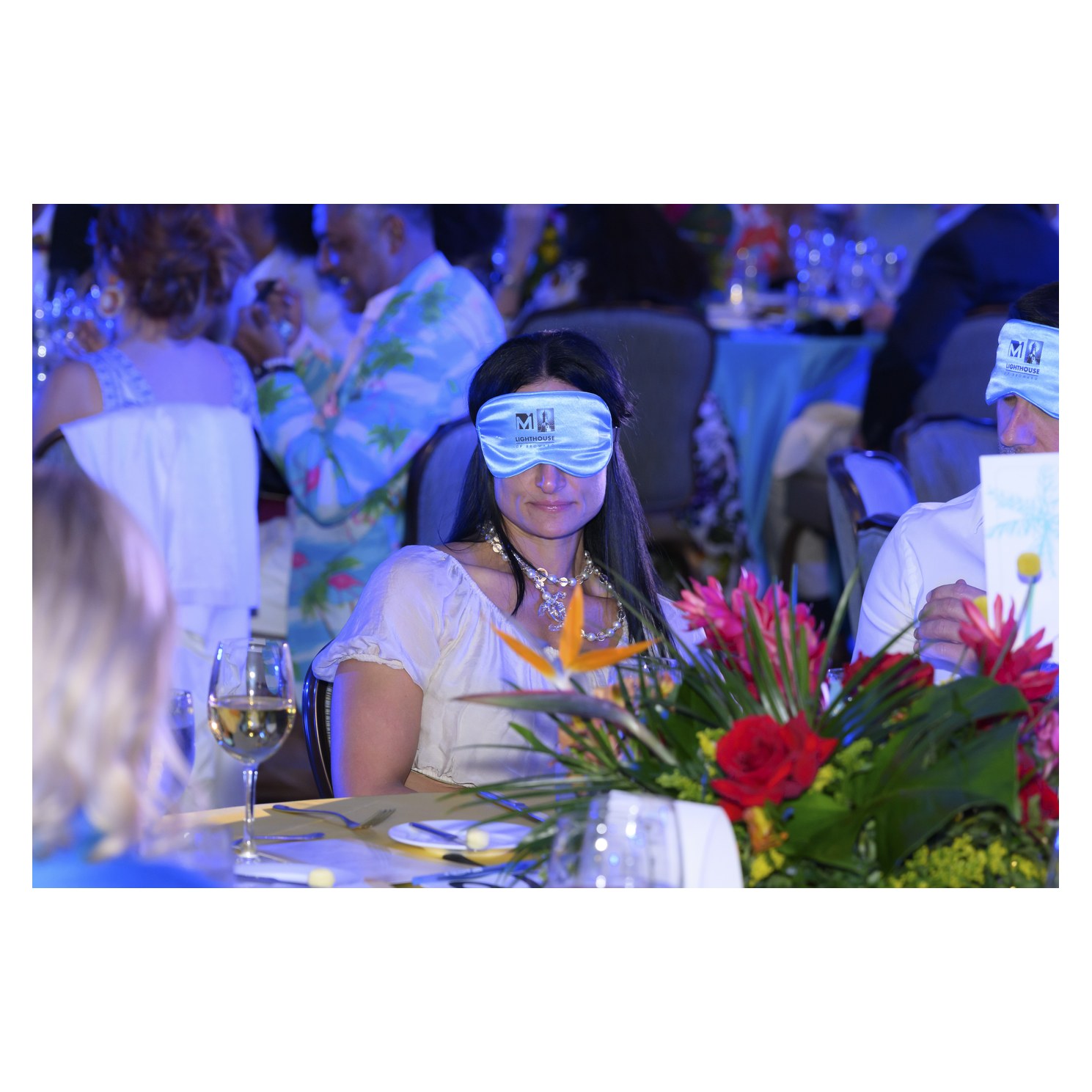 Guest wearing a blindfold at a Dining in the Dark dinner table