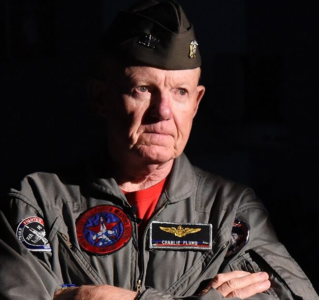 Captain Charlie Plumb in his Navy flight suit with squadron patches