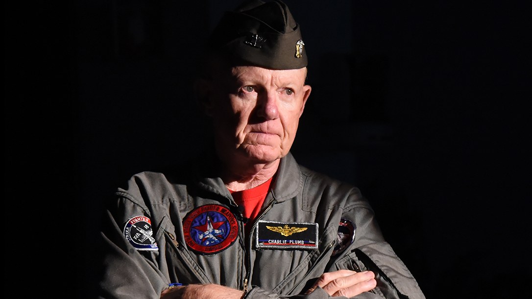 Captain Charlie Plumb in his Navy flight suit with squadron patches